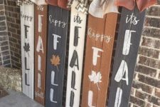 a number of fall signs in rust, black and white, all topped with contrasting burlap bows for more interest