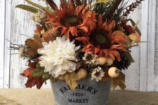 a rustic fall arrangement of rust and white faux blooms, berries, grasses, leaves and other stuff looks very cozy