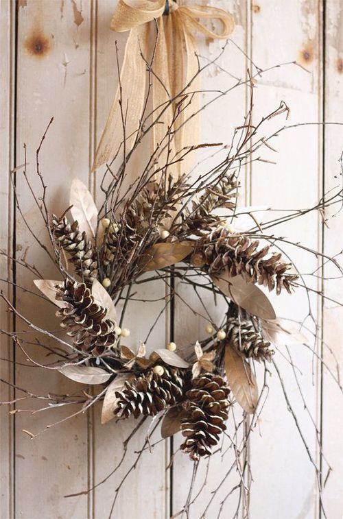 a rustic fall wreath of twigs, berries and pinecones plus dried leaves and a burlap bow is lovely and easy
