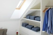 a sleek attic clothes storage item with open shelves and drawers is a stylish and comfortable idea for a small bedroom