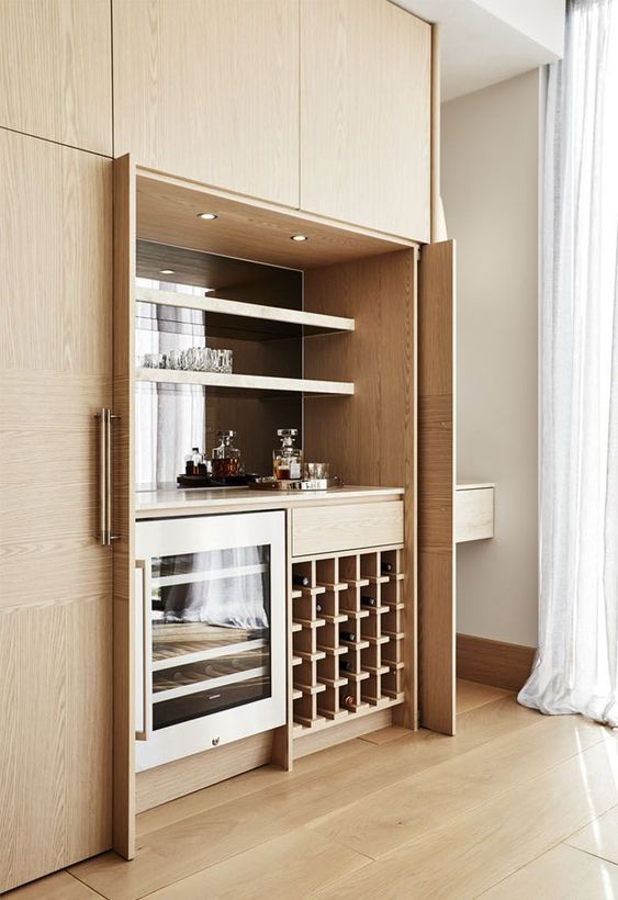 a small modern built-in bar with open shelves, a fridge and a wine bottle stand is a stylish idea that can be hidden
