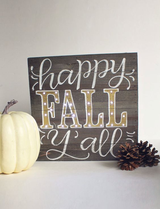 a stained wooden sign with white and gold letters is a chic and cute mantel decoration for the fall