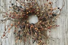 a twig and pip berry wreath is a natural and chic decoration for the fall