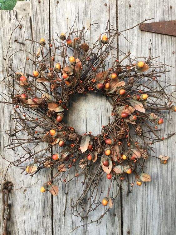 A twig fall wreath with acorns, berries, faux leaves and pinecones looks and feels very fall like