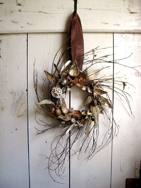 a twig fall wreath with acorns, dried leaves, nuts and gilded berries is a simple and natural idea
