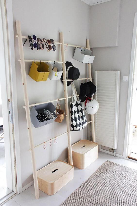 An open storage unit for accessories and shoes   some holders with hooks and boxes   closed and open supsended ones