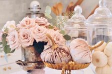blush velvet pumpkins, a blush candle and blush roses in a vintage urn are amazing for a glam fall centerpiece