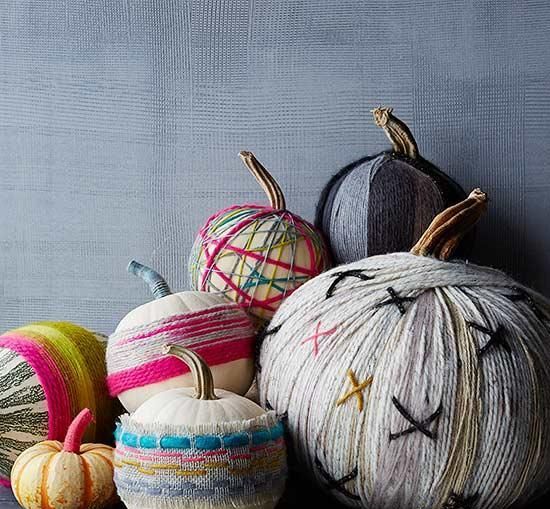 bright yarn pumpkins and neutral ones decorated with brigth fabric are easy DIYs to make for the fall
