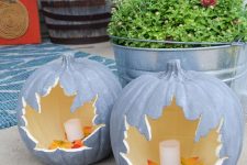 chalk painted pumpkins with cutout leaves and candles inside plus faux leaves are chic lanterns for indoors and outdoors