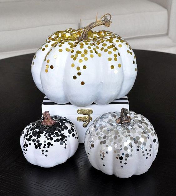 glam faux pumpkins decorated with gold, silver and black confetti to make your space very glam and chic
