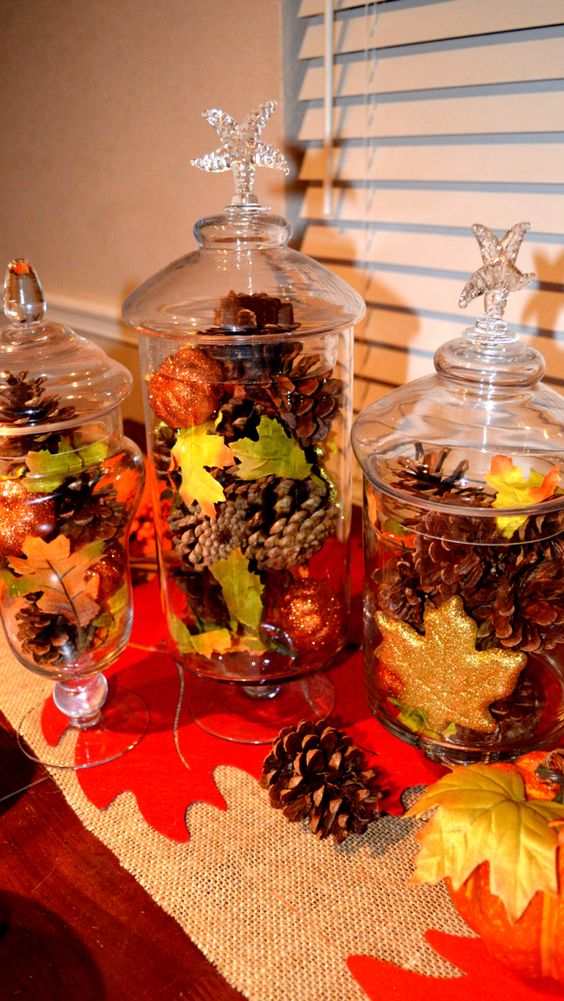 jars with lids and with glitter pumpkins, leaves and pinecones are a great and easy fall decoration