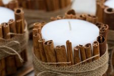 pillar candles covered with cinnamon bark and burlap will give a divine aroma to your space at once