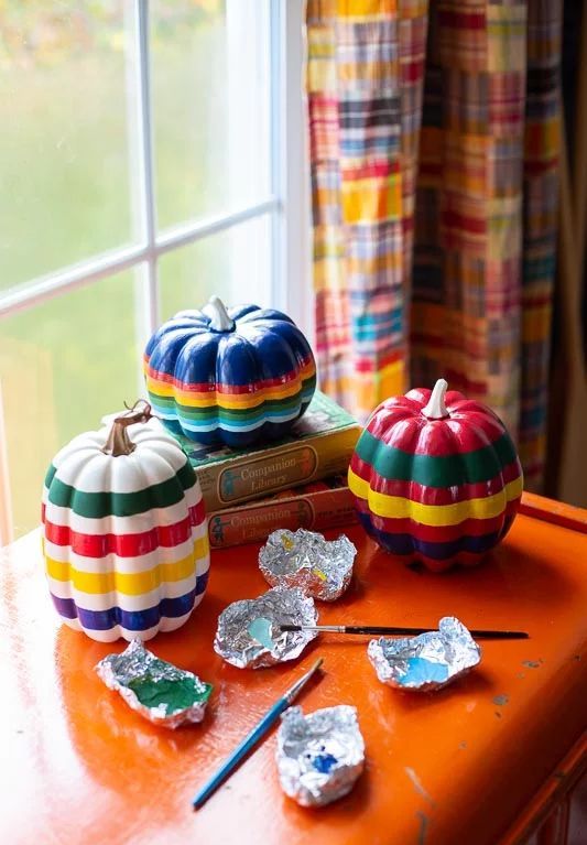Rainbow painted faux pumpkins are a fantastic bright idea for fall decor or for Thanksgiving