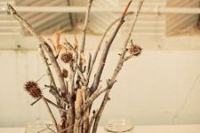 twigs with dried blooms and candles in jars with corn is a nice and easy fall centerpiece you can DIY