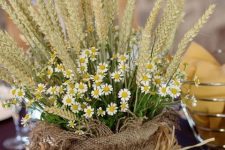 wheat and wildflowers in a burlap sack is a cool arrangement for the fall, it can be used as a centerpiece