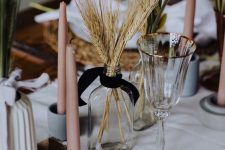 wheat in a clear bottle and pink candles for styling the table for the fall
