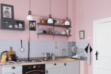 a lovely kitchen with pink walls