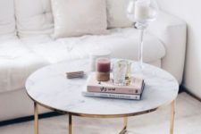 a glam marble coffee table with books, candles and glass coffee tables