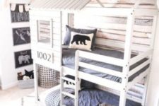 a house-shaped bunk bed unit for two, built-in lights and a ladder to reach the upper bed