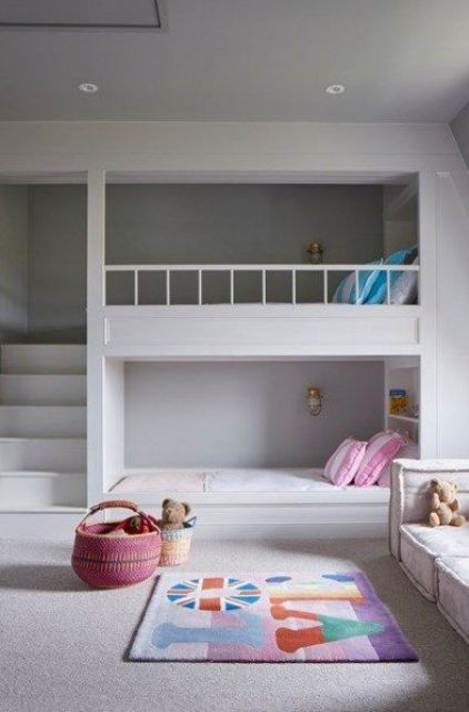 a minimalist room with bunk beds, a ladder and small wall lamps and shelves for storage