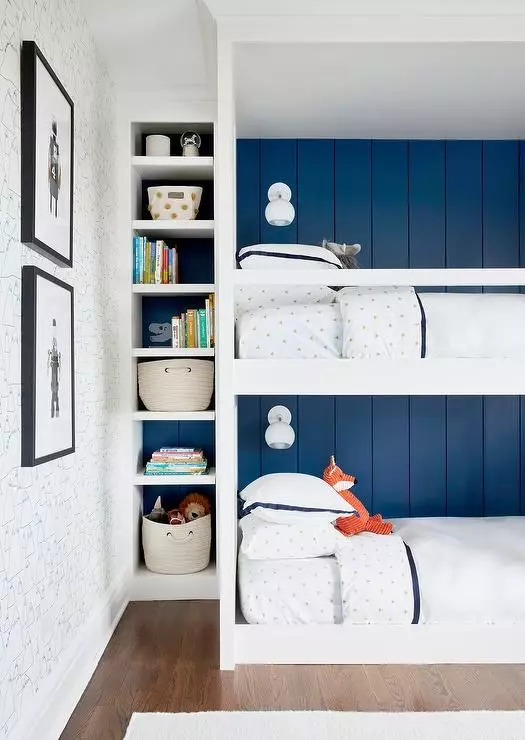 A modern and stylish kids' room with navy shiplap walls, a white bunk bed built in, built in shelves, baskets, toys and artwork welcomes in