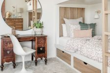 a neutral modern kids’ room with built-in bunk beds, printed bedding, a vintage stained desk and a round mirror, printed rugs