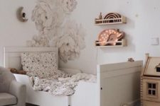 a neutral romantic kid’s room with handpainted florals, a white Sundvik bed, a banner, a playhouse and baskets