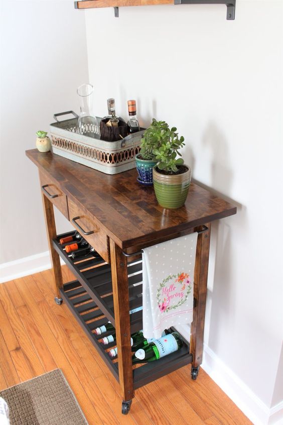 A rich stained IKEA Forhoja cart with a butcher block countertop becomes a mid century modern home bar