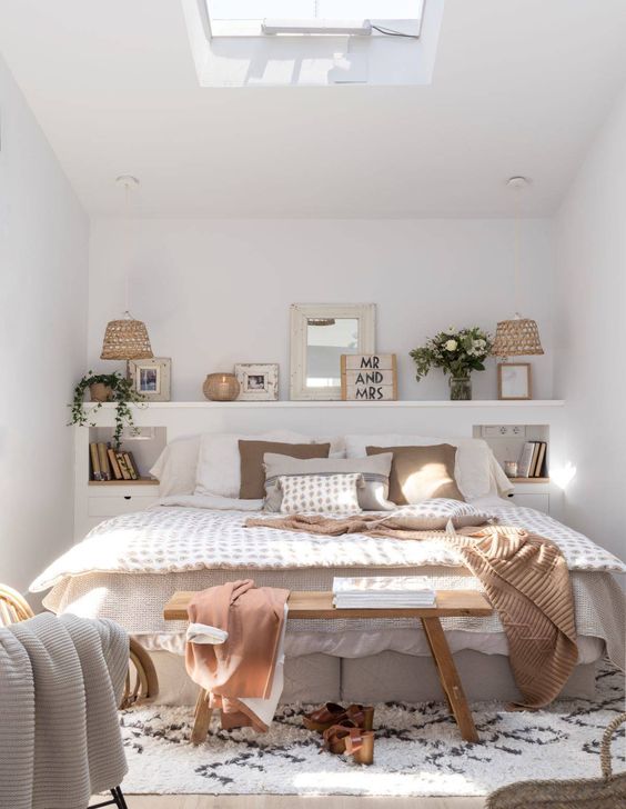 a shelf, a skylight and a neutral color scheme make the bedroom look bigger and more welcoming