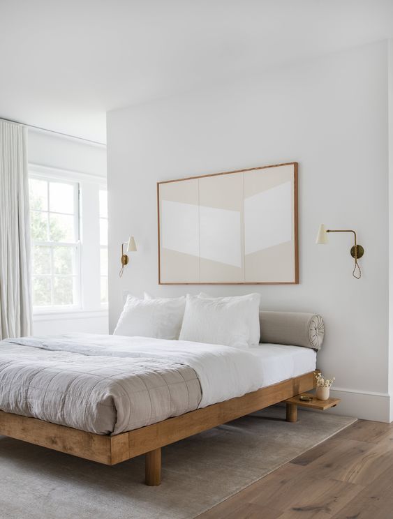 a small bedroom made visually exapanded with a neutral color scheme and an oversized art over the bed