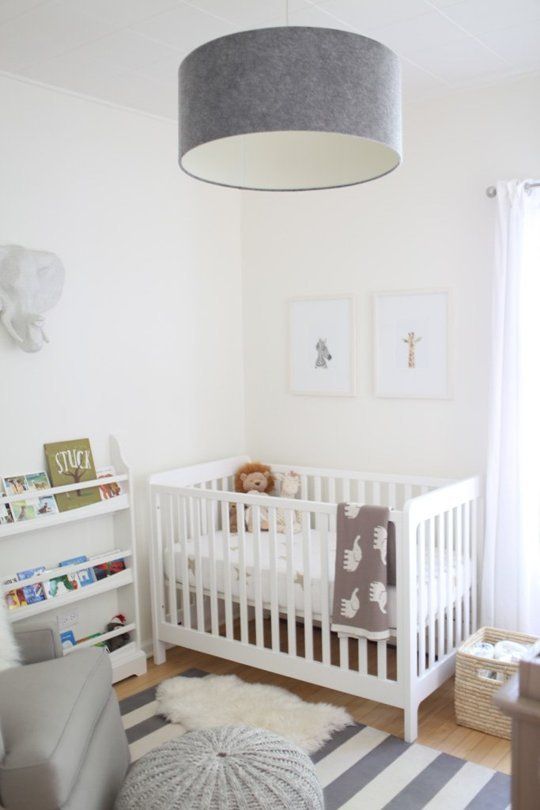 a soothing neutral nursery with an IKEA Sundvik crib, grey touches, faux fur and an open bookshelf