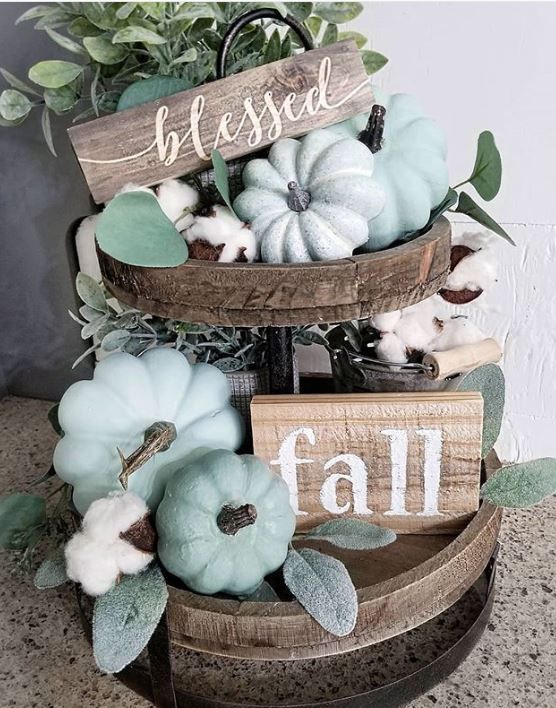 a tiered wooden stand with milky paint and green pumpkins, cotton, wooden signs and greenery as a chic fall centerpiece