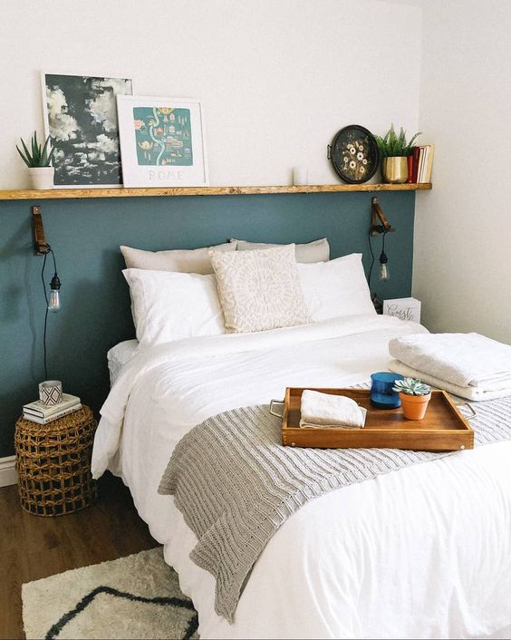 a tiny bedroom made large with a ledge that widens it and a neutral color scheme that makes it visually bigger