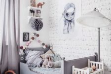 a whimsy grey kid’s room with cool artworks, a garland, shelves, a grey Sundvik bed and grey curtains