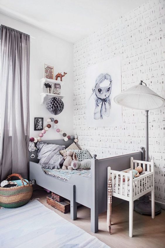 a whimsy grey kid's room with cool artworks, a garland, shelves, a grey Sundvik bed and grey curtains