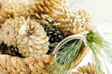 a wicker bowl with usual and bleached pinecones looks pretty – just add some evergreens