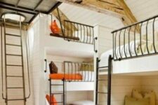 an awesome kids’ room with several built-in bunk beds, bright and white bedding, metal ladders and a printed rug