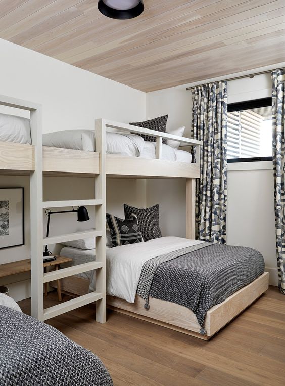 an elegant modern kids' room in a monochromatic color scheme, with bunk beds, graphic bedding and curtains is a chic idea