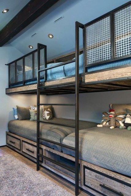 An industrial kids' bedroom with built in bunk beds of blackened steel and wood, with storage drawers and grey and blue bedding