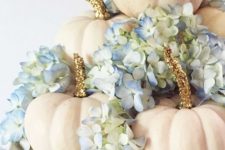 creamy pumpkins with glitter stems, blue hydrangeas on a white porcelain stand as a glam rustic fall centerpiece