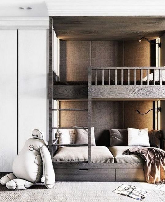 dark stained bunk beds with a ladder and storage drawers plus contemporary wall lights
