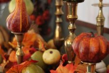 faux pumpkins and pearls on metallic stands, with faux leaves and veggies under them for a chic fall arrangement