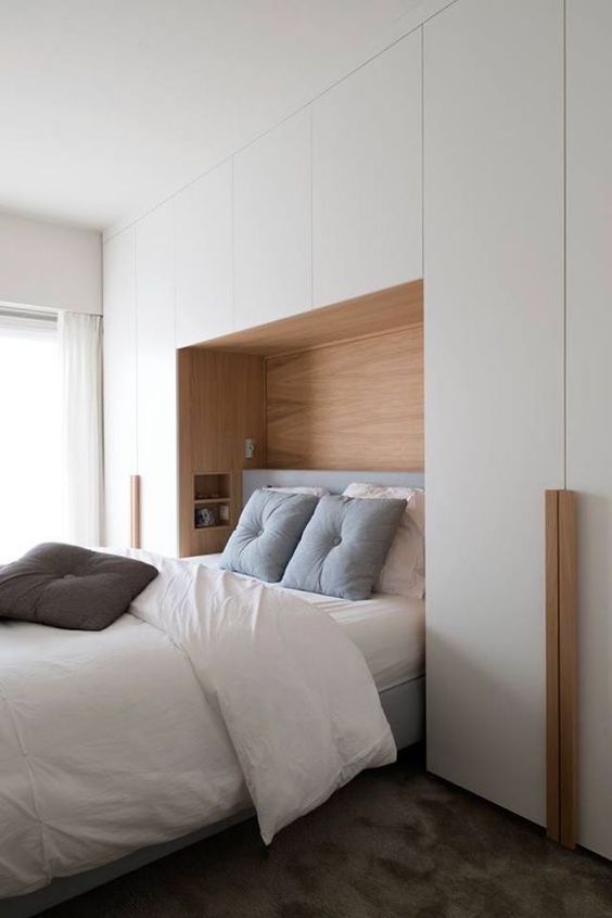 floor to ceiling sleek furniture gives much storage space, doesn’t clutter the bedroom and makes it bigger