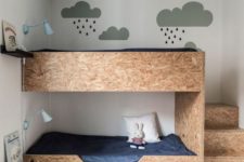 plywood bunk beds with storage drawers and blue wall sconces for a quirky and fun room