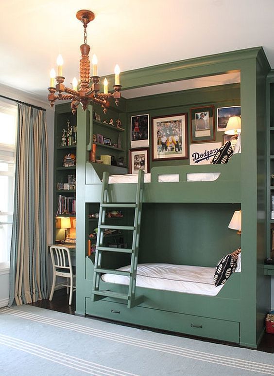 stylish green bunk beds with intergrated storage drawers, a ladder, wall lamps and a gallery wall