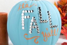 a blue pumpkin decorated with orange letters and some decorative nails for fall and Thanksgiving