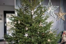 a minimalist Christmas tree with lights, a bit of gold, white, silver and black ornaments is a stylish piece to rock and it looks amazing