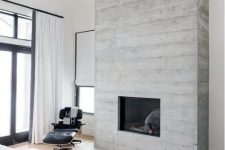 a modern bedroom with a concrete fireplace