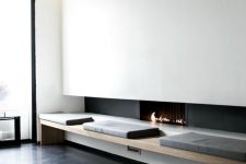 a modern ethanol fireplace, a comfy bench next to it bring a touch of luxury to the interior