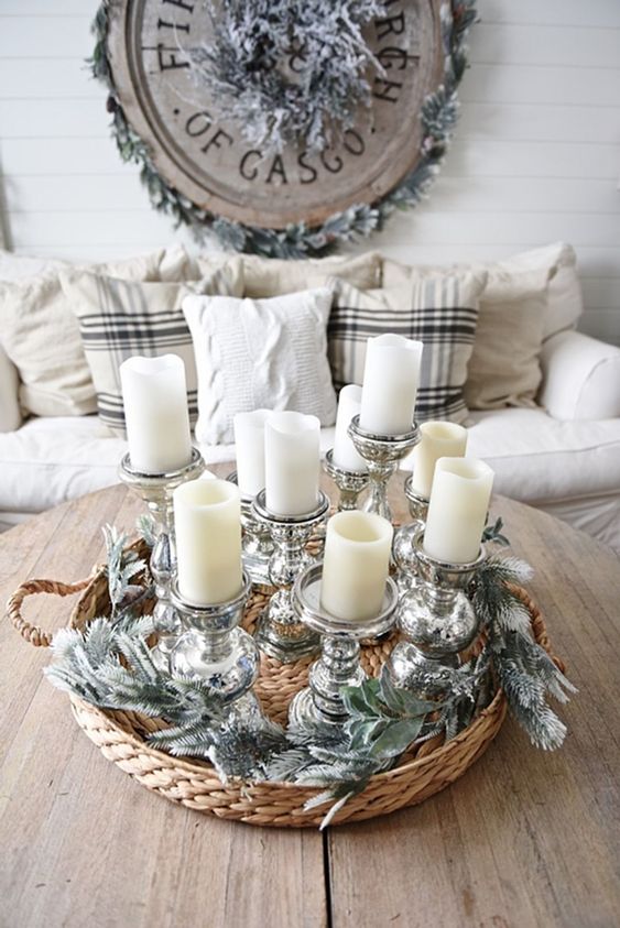 an arrangement of pillar candles in elegant metallic candle holders is a very chic and cool decoration for a winter space